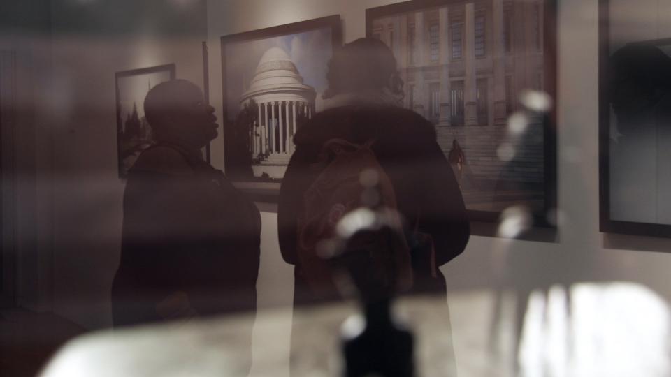 Two people looking at art.