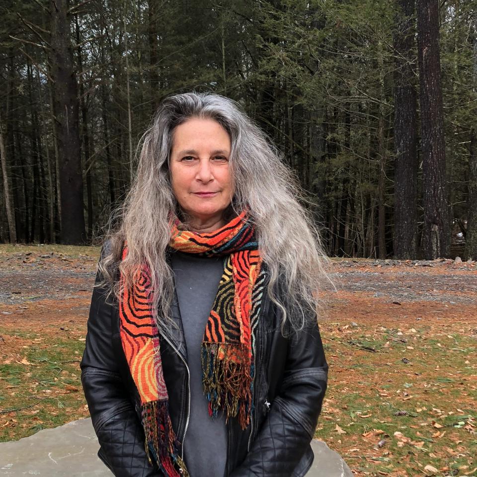 A photo of a woman standing outside.
