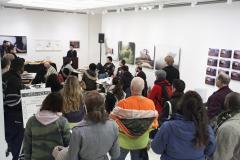 A photo of a group of people watching a presentation.
