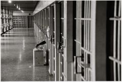 A man playing chess in jail.