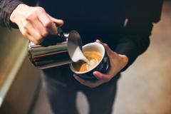 A person making a latte.