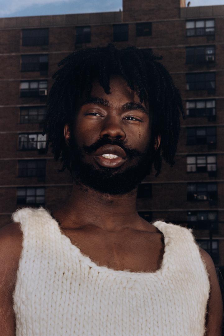 A picture of the face of a man with a tear.