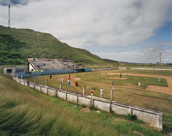 People playing baseball at a field.