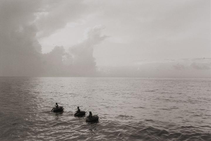Three people in the ocean.