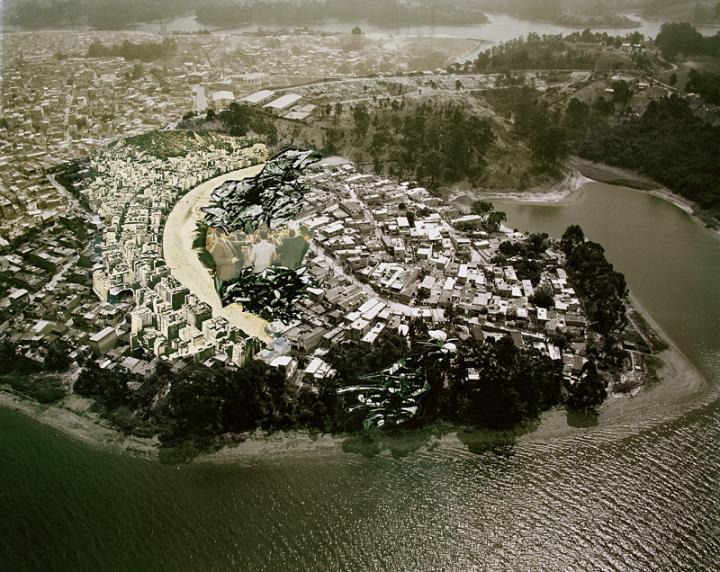 A cityscape on a peninsula as seen from high above the water. 