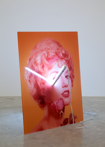 A painting with a light fixture attached to it